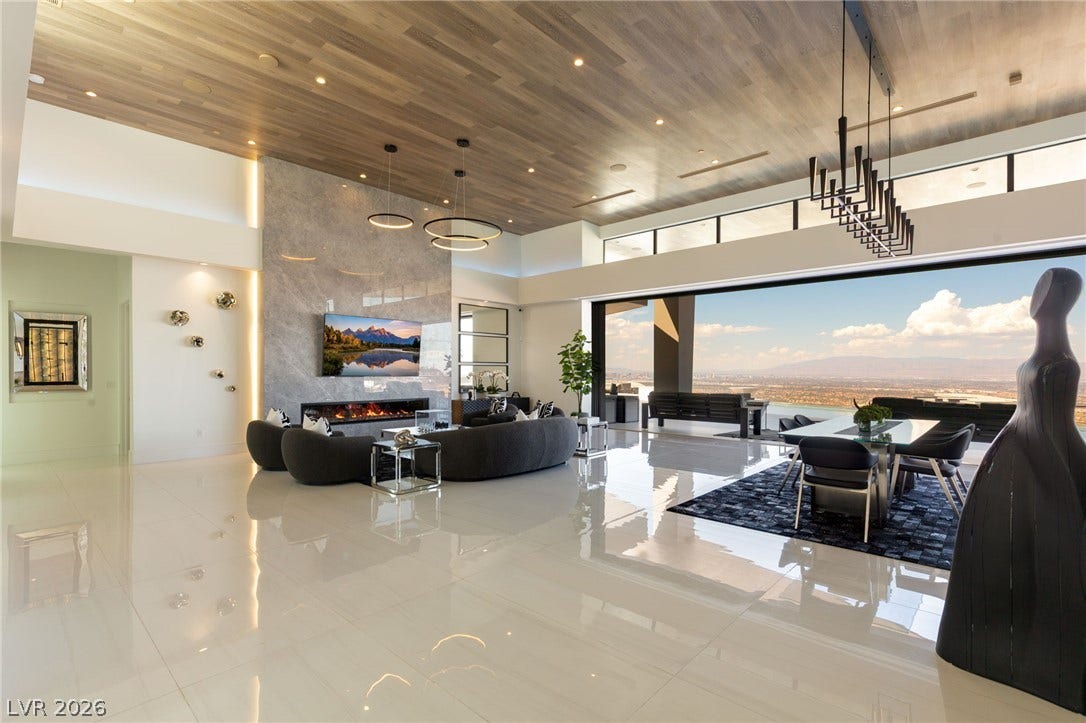 4 Chisel Crest Court, Henderson, NV 89012 Gleaming polished tile floors and rich wood-plank ceilings frame an expansive living area with sweeping views.