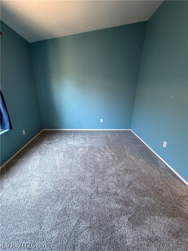 A well-maintained carpeted room offers a versatile space for rest or recreation.
