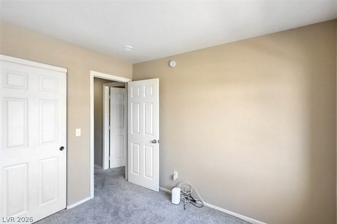 A well-maintained interior space features soft grey carpeting and clean white trim.