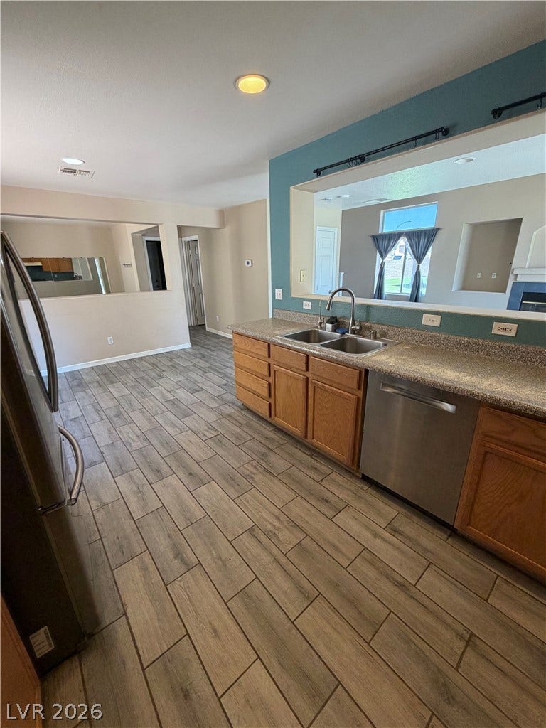 A well-appointed kitchen boasts sleek countertops, modern appliances, and a convenient pass-through window to the living area.