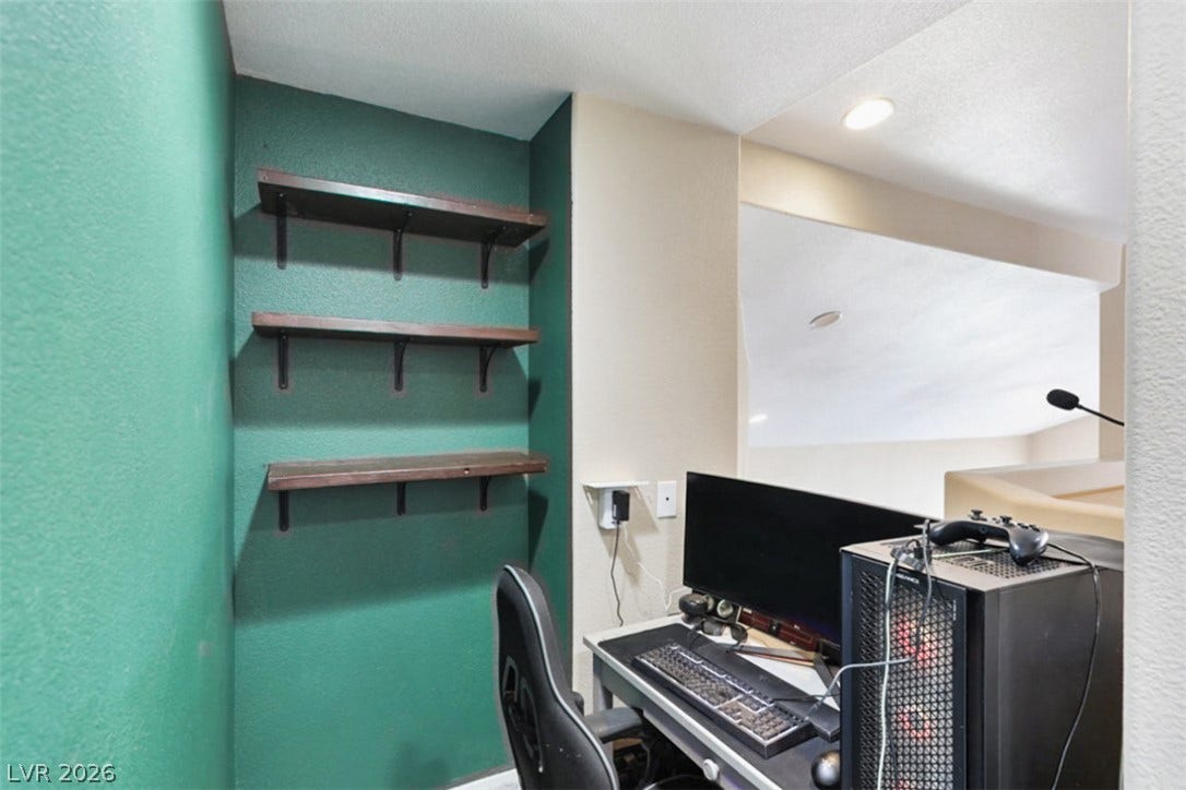 Built-in shelving and ample desk space create a dedicated and organized workspace.