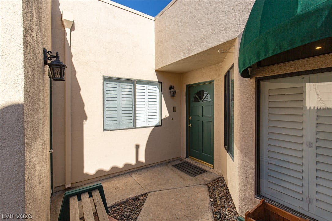 2882 Bridgepointe Drive, Las Vegas, NV 89121 A welcoming stucco courtyard leads to a private recessed entry door.