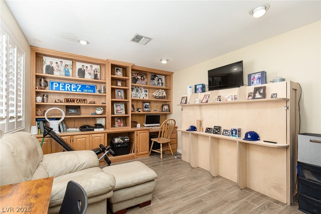 2882 Bridgepointe Drive, Las Vegas, NV 89121 An integrated wood desk and extensive built-in shelving complement the durable tile flooring.