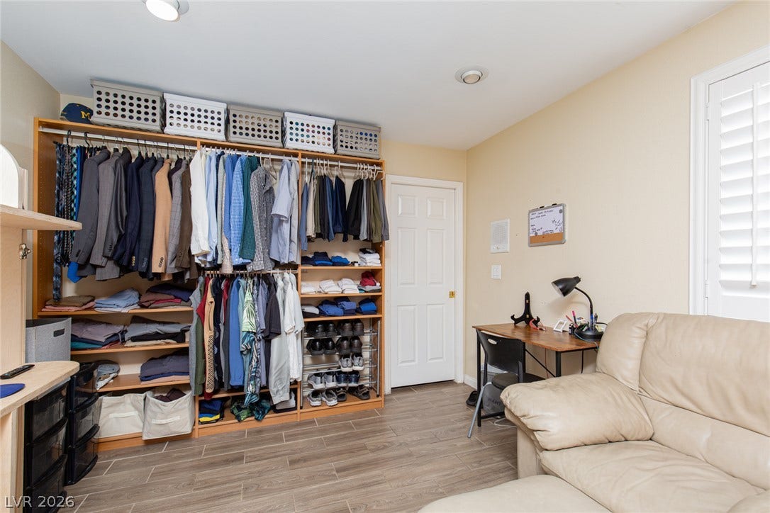 2882 Bridgepointe Drive, Las Vegas, NV 89121 Rich wood-look flooring and custom built-in organization system define this versatile space.
