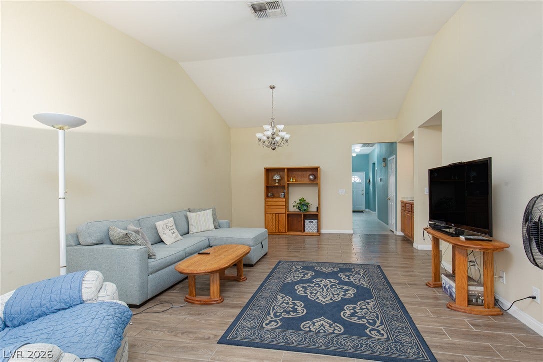 2882 Bridgepointe Drive, Las Vegas, NV 89121 Vaulted ceilings soar over durable tile flooring in this inviting open-concept living area.