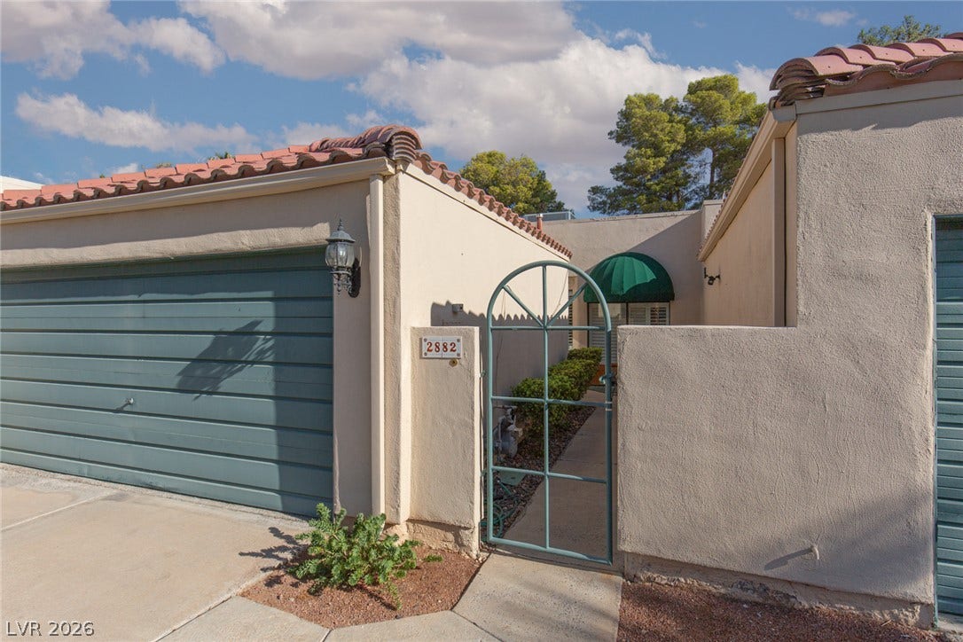 2882 Bridgepointe Drive, Las Vegas, NV 89121 Spanish tile roofing and a private gated entry courtyard welcome you home.