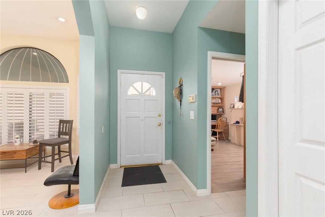 2882 Bridgepointe Drive, Las Vegas, NV 89121 A welcoming entryway transitions into light-filled living spaces and a private home office.
