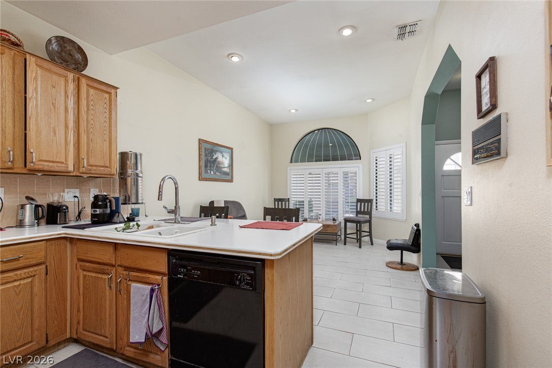 2882 Bridgepointe Drive, Las Vegas, NV 89121 Hardwood cabinetry and tile flooring define this functional, open kitchen layout.