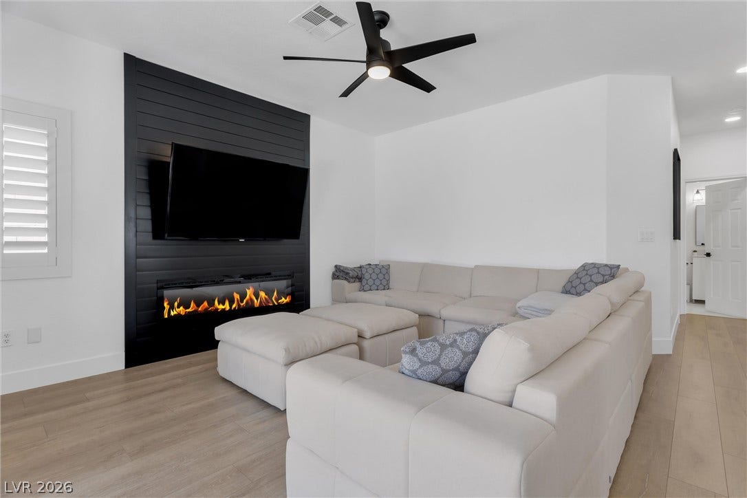 337 Teal Ridge Hills Drive, Henderson, NV 89014 Smooth wood floors and a contemporary fireplace define this inviting living space.