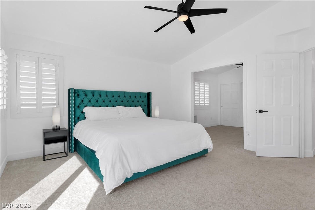 337 Teal Ridge Hills Drive, Henderson, NV 89014 Crisp white walls and plush carpeting define this serene master suite featuring plantation shutters.