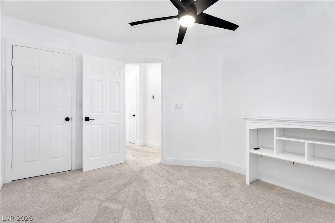 337 Teal Ridge Hills Drive, Henderson, NV 89014 Plush carpeting and custom built-in shelving anchor this versatile interior space.