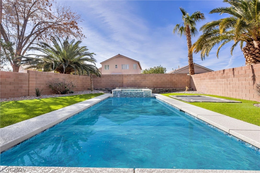 337 Teal Ridge Hills Drive, Henderson, NV 89014 Palm trees frame a sparkling swimming pool in a private, walled backyard oasis.