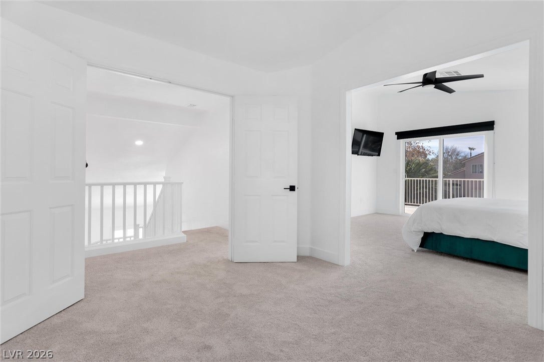 337 Teal Ridge Hills Drive, Henderson, NV 89014 Crisp white walls and plush carpeting flow seamlessly from the landing into the bedroom space.