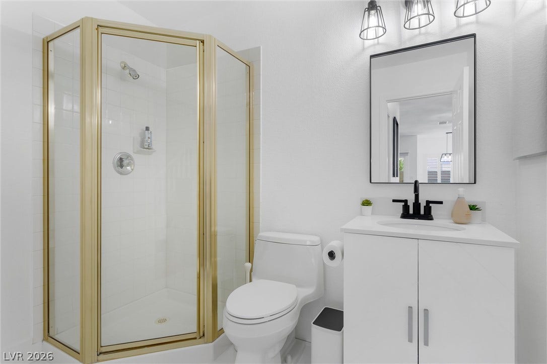 337 Teal Ridge Hills Drive, Henderson, NV 89014 Clean lines and a framed glass shower define this functional bathroom space.