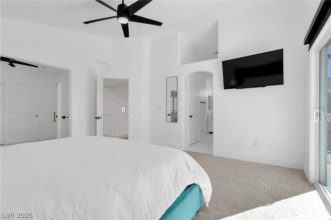337 Teal Ridge Hills Drive, Henderson, NV 89014 High vaulted ceilings and plush carpeting anchor this light-filled modern bedroom retreat.