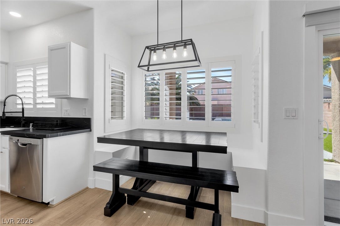 337 Teal Ridge Hills Drive, Henderson, NV 89014 Sunlight streams through plantation shutters into an inviting dining area with light wood-style flooring.