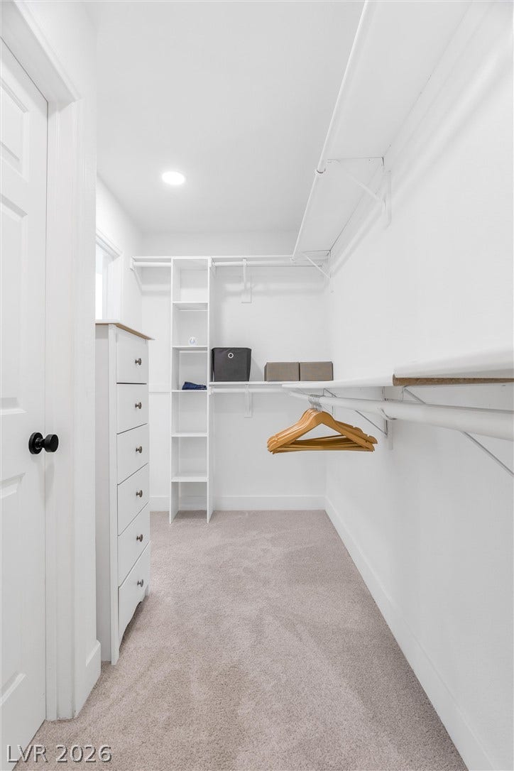 337 Teal Ridge Hills Drive, Henderson, NV 89014 A well-organized walk-in closet boasts built-in shelving and soft carpet underfoot.