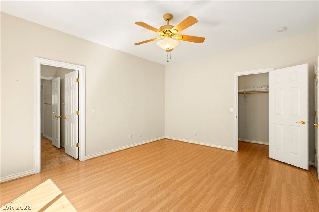 Warm wood flooring and clean neutral walls define this secondary bedroom space on the upper floor