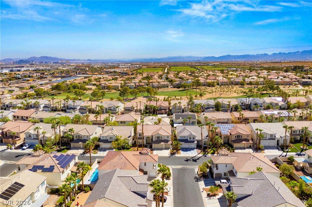 An aerial perspective captures this master-planned neighborhood set against a backdrop of distant mountain ranges.