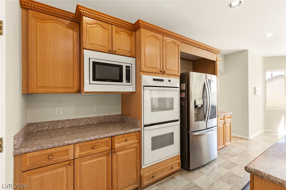 Rich wood cabinetry and integrated appliances define this functional gourmet kitchen.