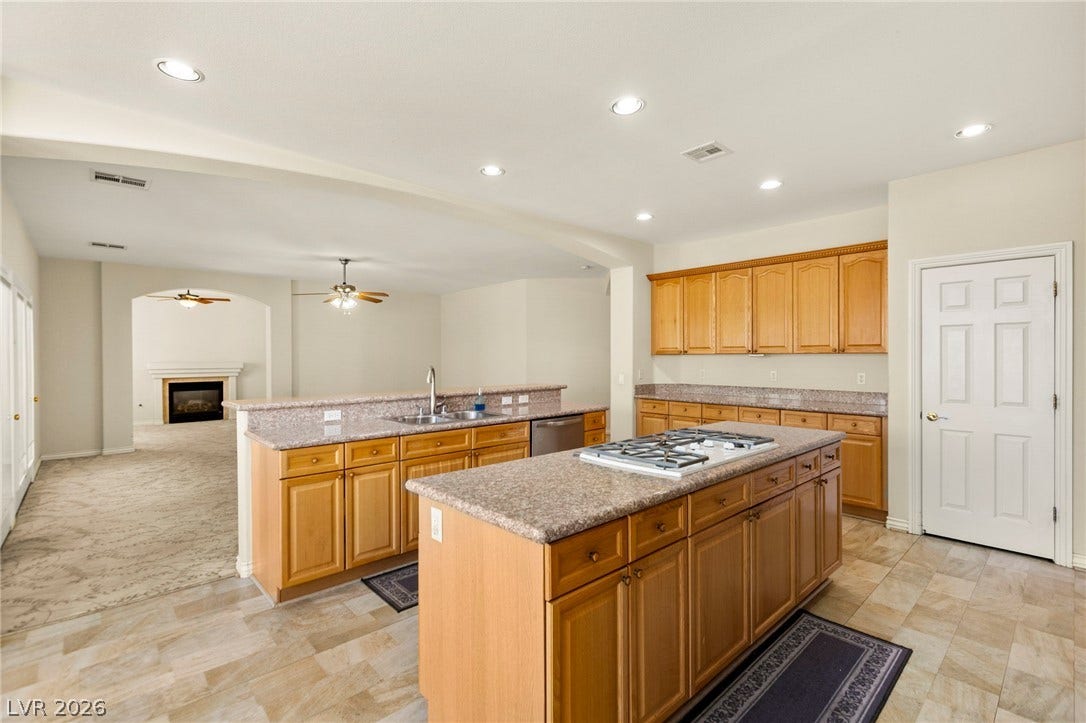 An open layout connects the spacious gourmet kitchen to the living area and beyond.