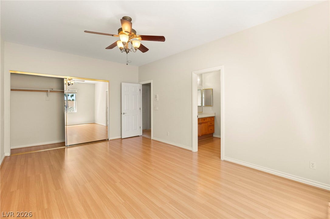 Warm wood floors run through this spacious upper floor bedroom featuring a mirrored closet and attached full bath.