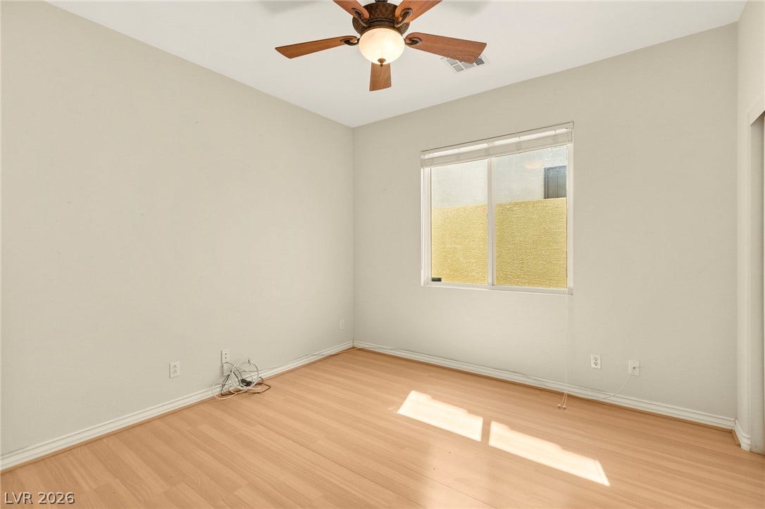 Main Floor bedroom with wood flooring and natural light create a welcoming atmosphere.