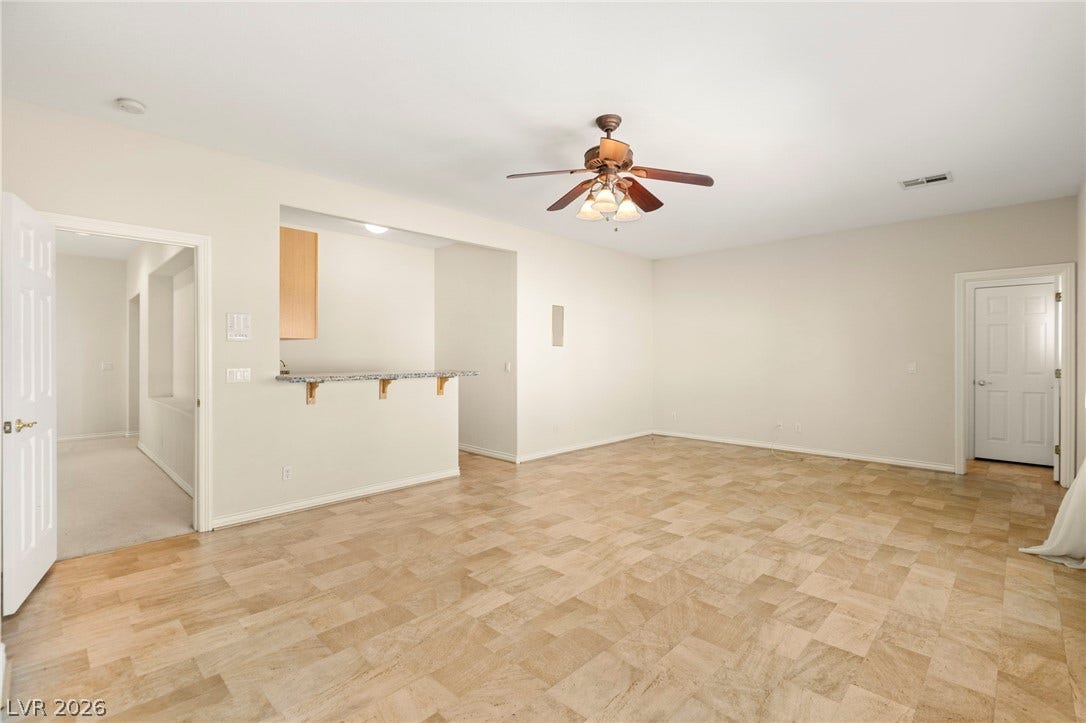Located on the upper floor, this massive enclosed den is larger than most primary bedrooms, filled with tons of natural light, and features its own wet bar, making it an ideal sixth bedroom.