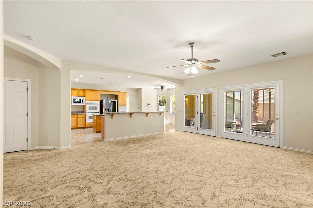 A spacious layout connects the main living area directly to the kitchen and adjacent to extended sunroom.