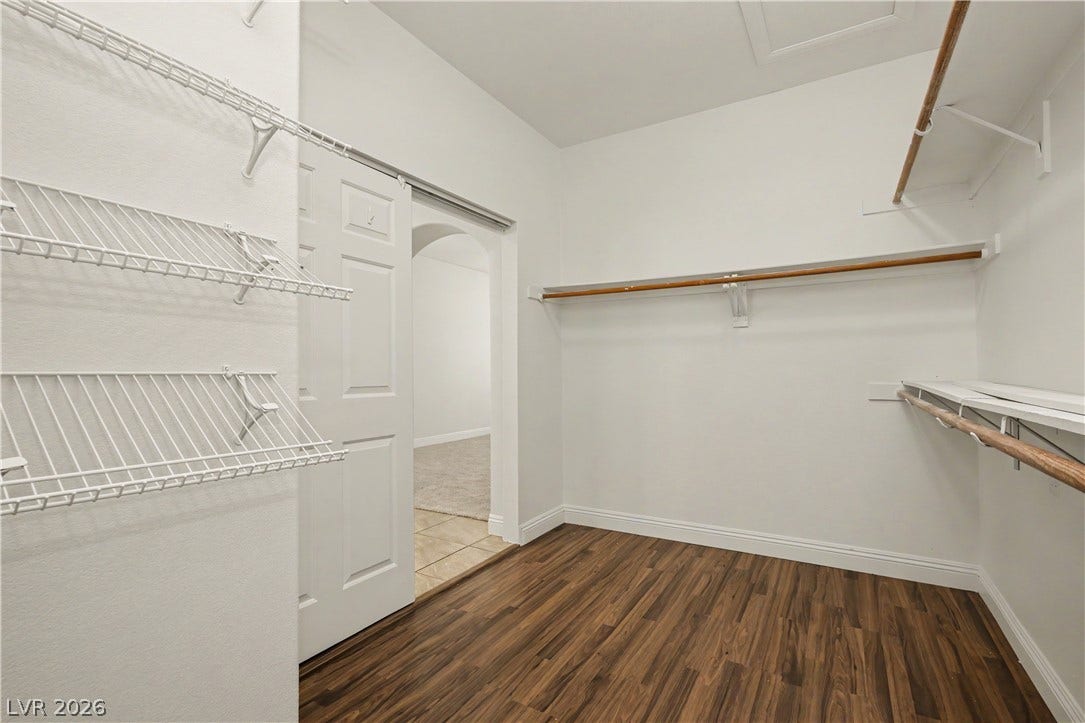 1424 Clipperton Avenue, Henderson, NV 89074 Rich wood floors lay beneath multiple rows of built-in shelving inside a spacious closet.