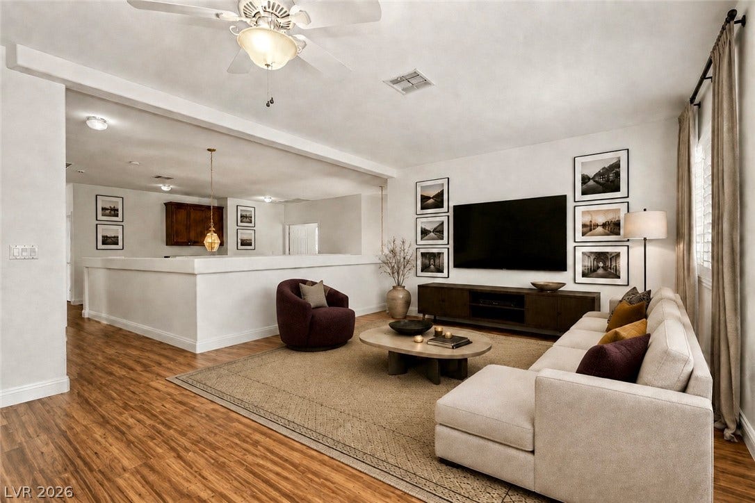 1424 Clipperton Avenue, Henderson, NV 89074 Virtually staged.
Rich wood flooring anchors this inviting, open-plan living area framed by crisp white walls.