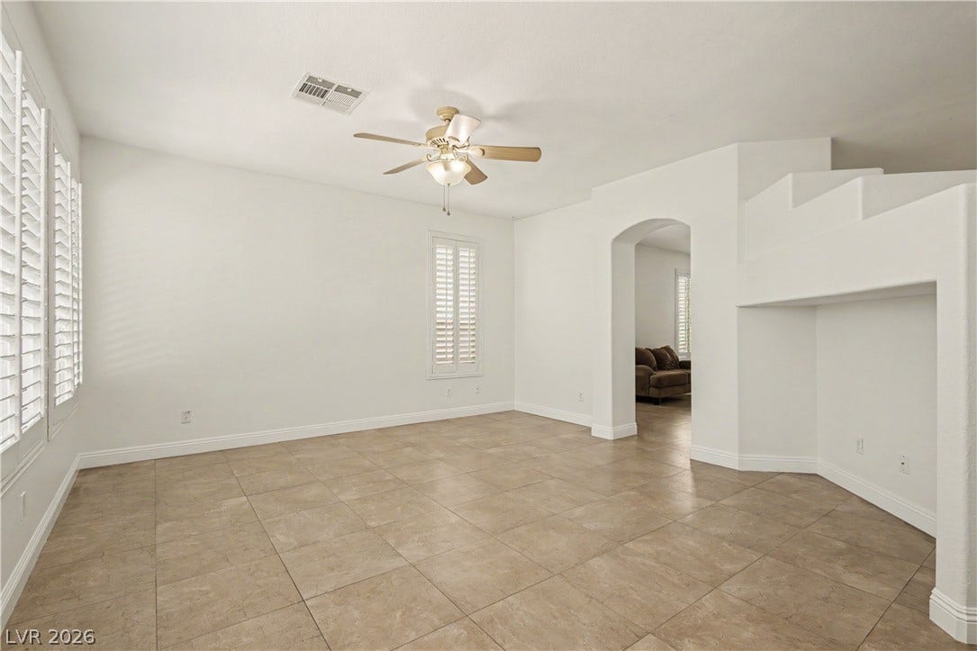 1424 Clipperton Avenue, Henderson, NV 89074 Tiled flooring and crisp white walls define this versatile interior space with an arched doorway.
