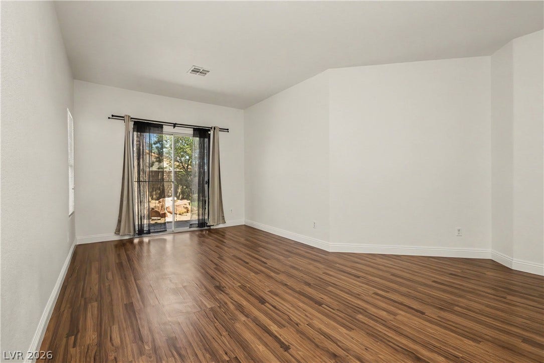 1424 Clipperton Avenue, Henderson, NV 89074 Rich wood-look flooring and sliding glass doors create an inviting, open atmosphere.