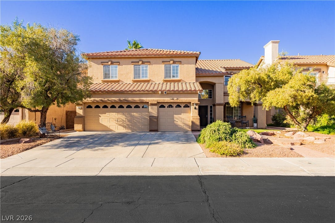 1424 Clipperton Avenue, Henderson, NV 89074 Spanish tile roof accents highlight the classic stucco exterior and paved driveway of this residence.