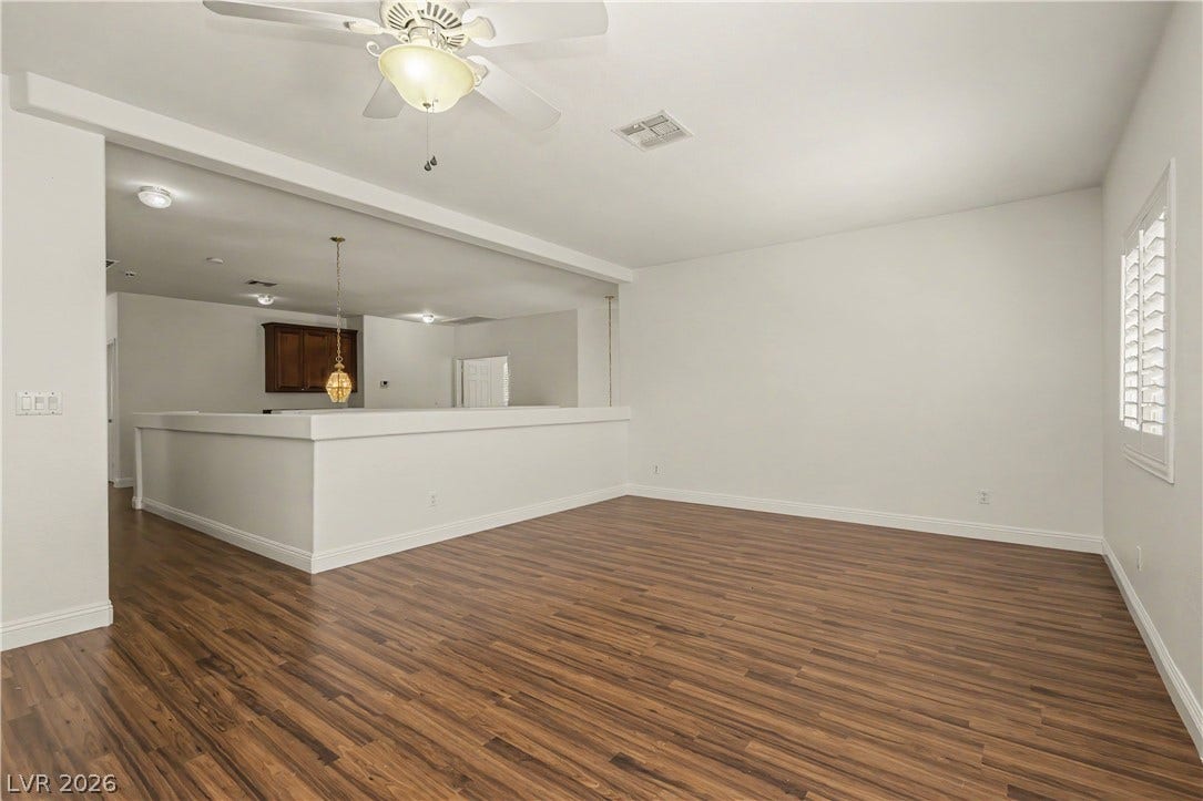 1424 Clipperton Avenue, Henderson, NV 89074 Rich wood-look flooring and plantation shutters define this versatile, open living area.