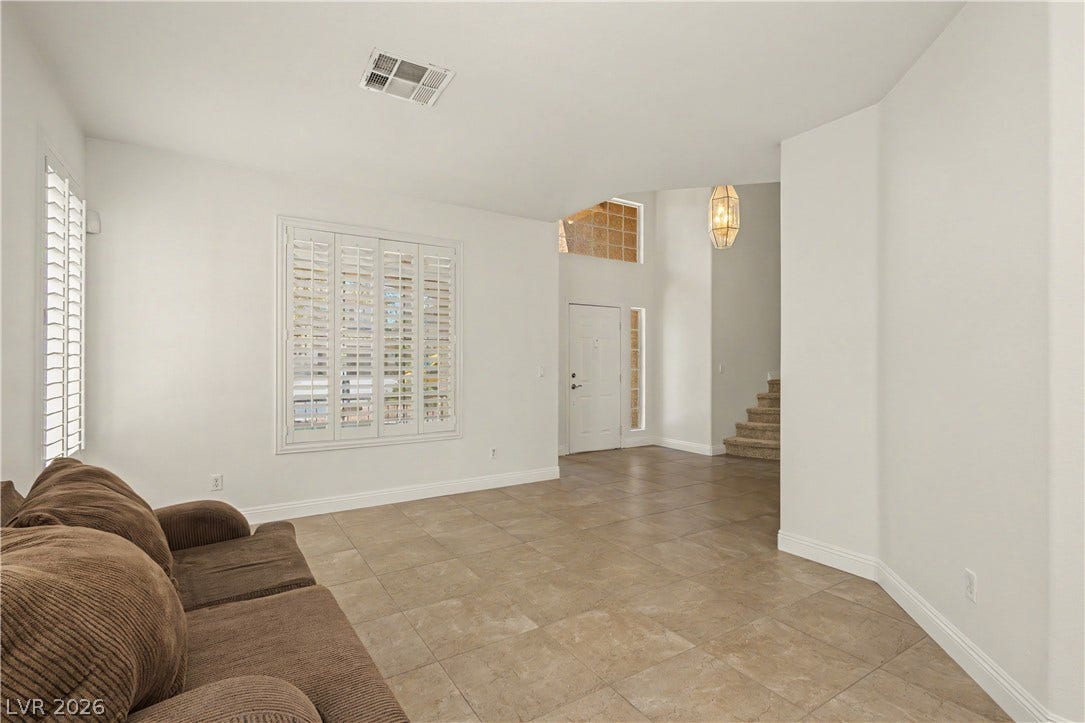1424 Clipperton Avenue, Henderson, NV 89074 Tiled flooring flows through an open-concept living space accented by plantation shutters and high ceilings.