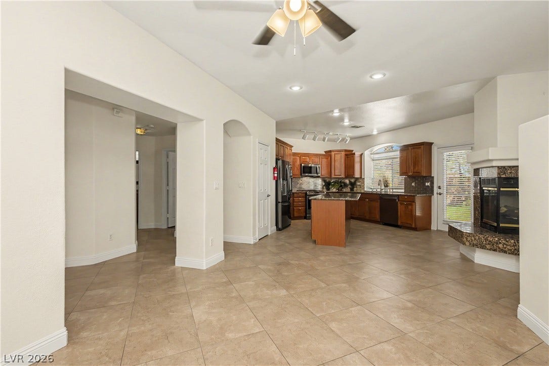 1424 Clipperton Avenue, Henderson, NV 89074 Tiled floors and a cozy fireplace anchor this open-concept layout leading into the kitchen.