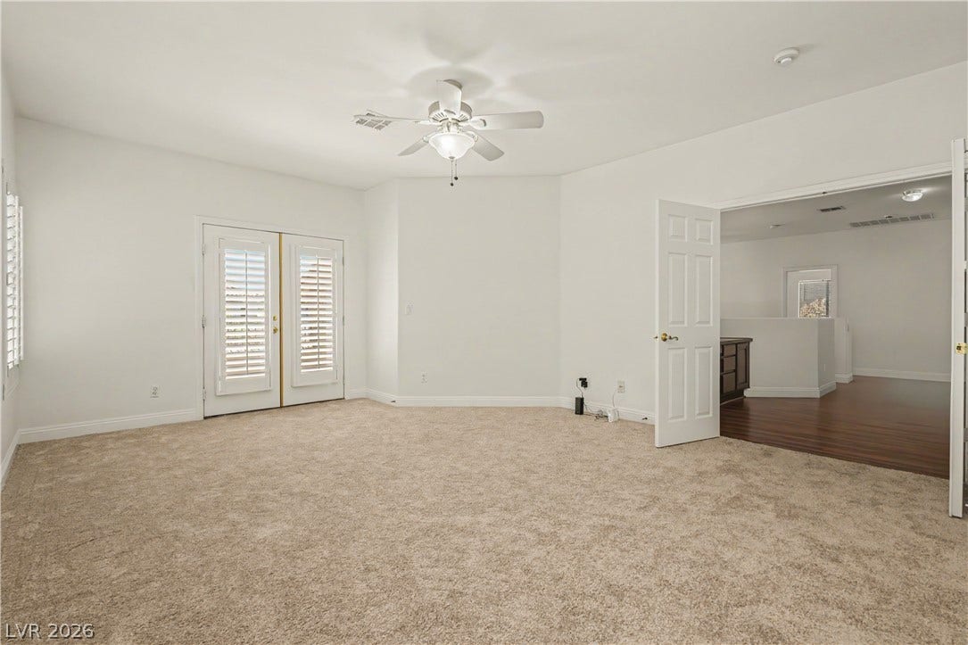 1424 Clipperton Avenue, Henderson, NV 89074 Double doors open to a spacious upper level room with soft carpeting and classic millwork.