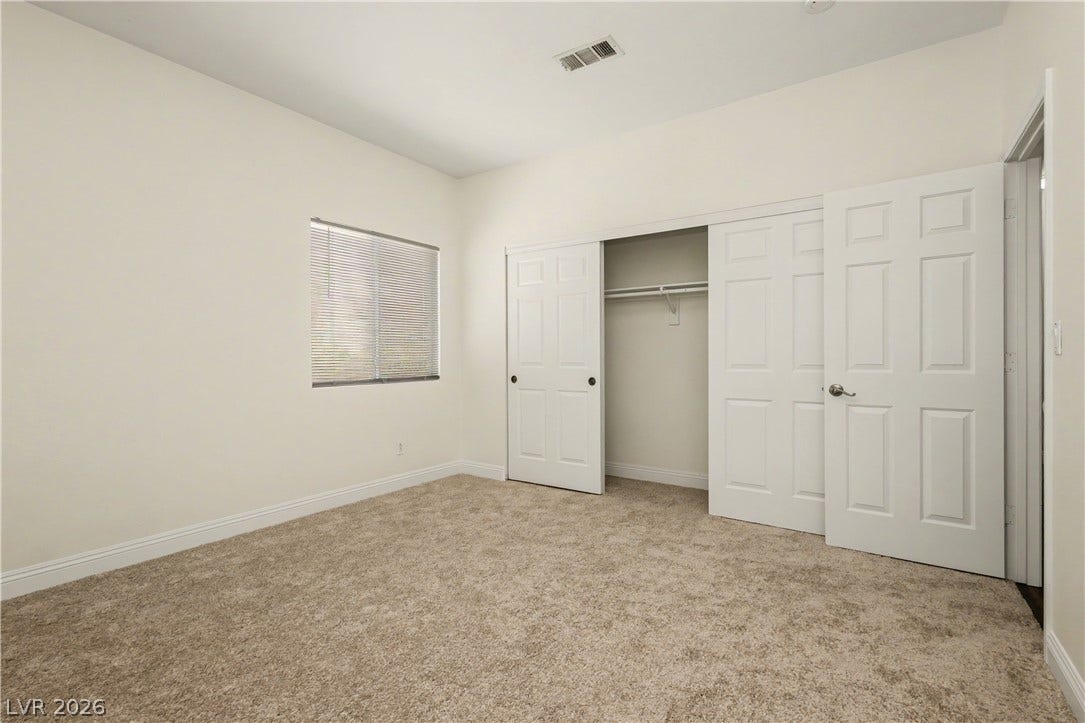 1424 Clipperton Avenue, Henderson, NV 89074 Plush carpeting and integrated closet storage anchor this versatile secondary bedroom space.