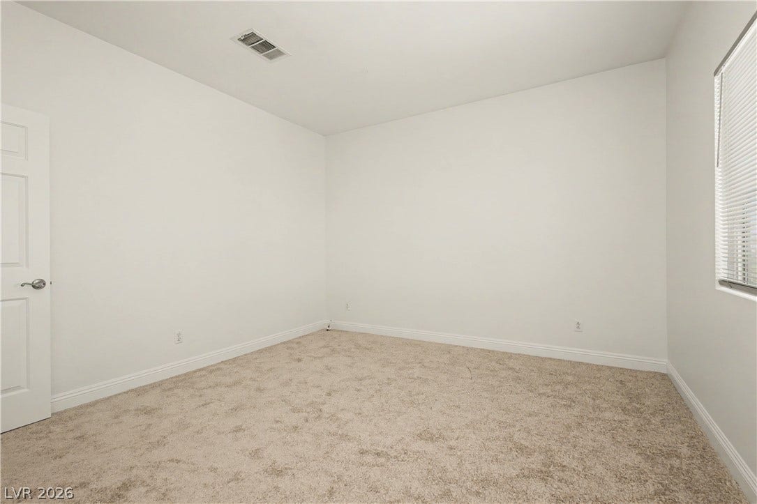 1424 Clipperton Avenue, Henderson, NV 89074 Smooth plaster walls and soft carpeting define this versatile secondary room.