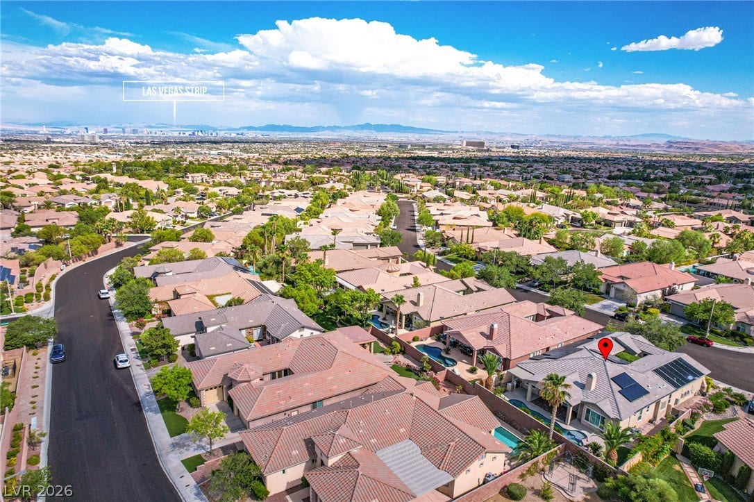 An aerial perspective showcases a quiet residential neighborhood with distant views of the mountain range.