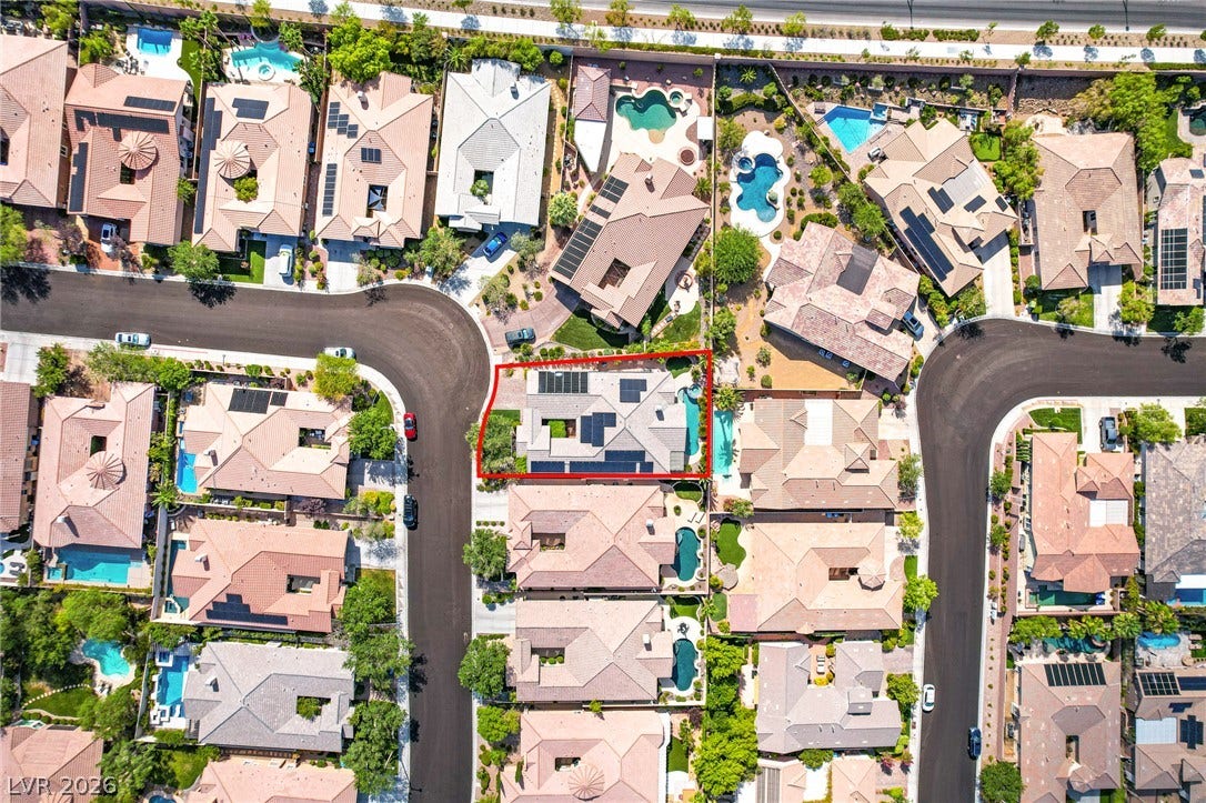 An aerial perspective showcases the home within a quiet, manicured suburban neighborhood.