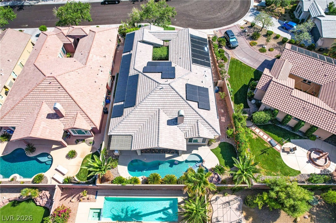 An aerial perspective reveals the custom tiled roofline and private backyard swimming pool.