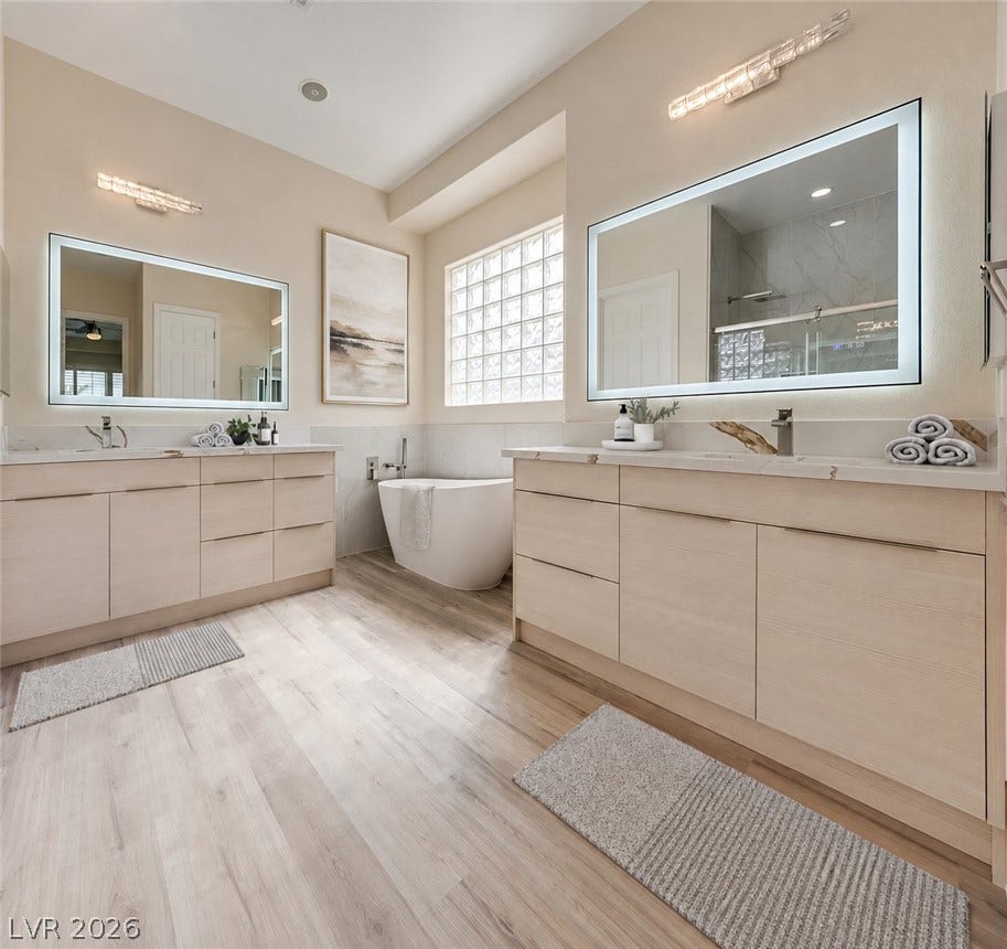 Clean lines and a freestanding soaking tub define this modern, light-filled bathroom design.
