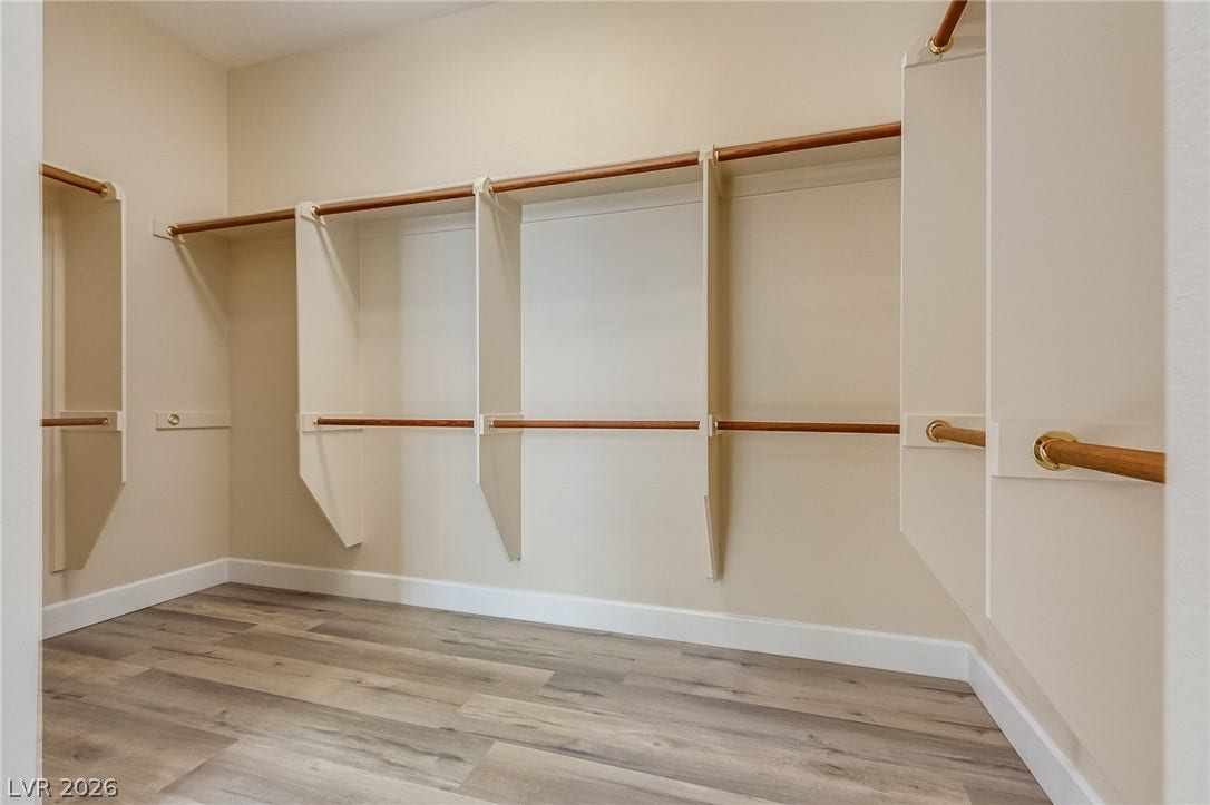 Ample built-in storage and durable wood-look flooring maximize organization in this closet.
