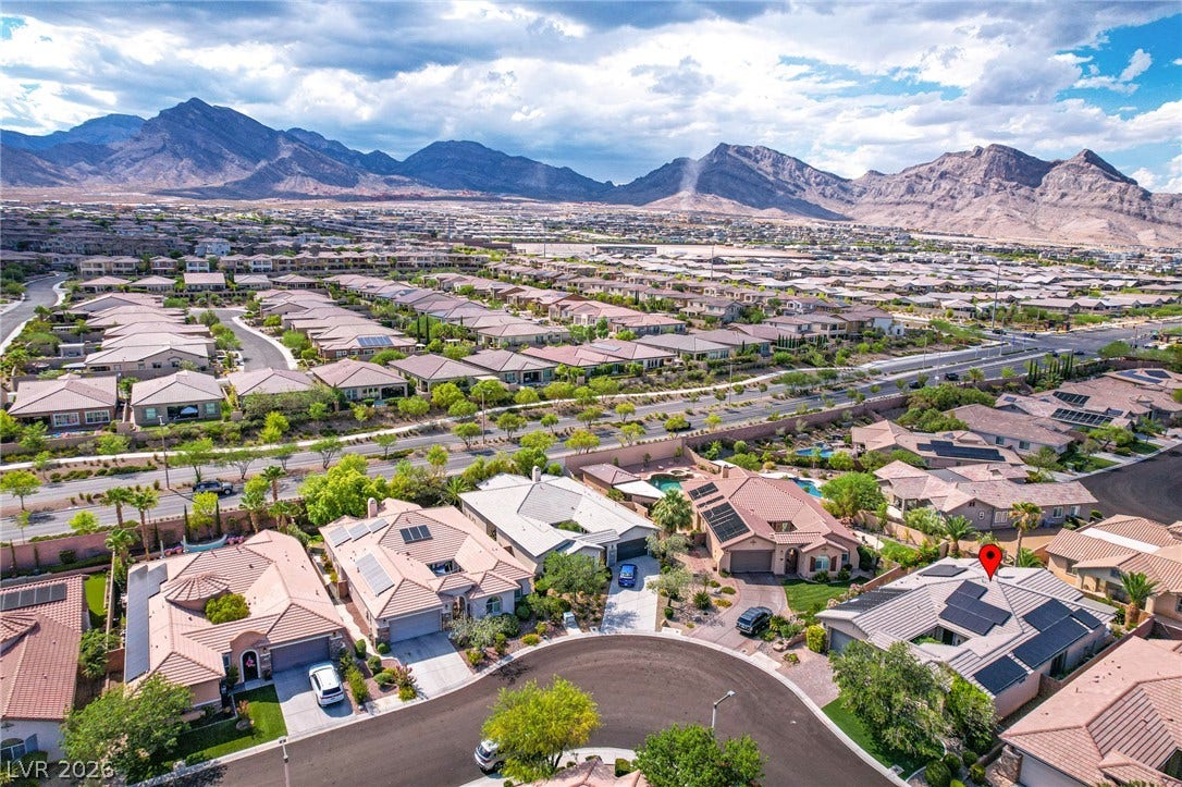 Dramatic mountain ranges frame this tranquil residential neighborhood of tiled-roof homes.