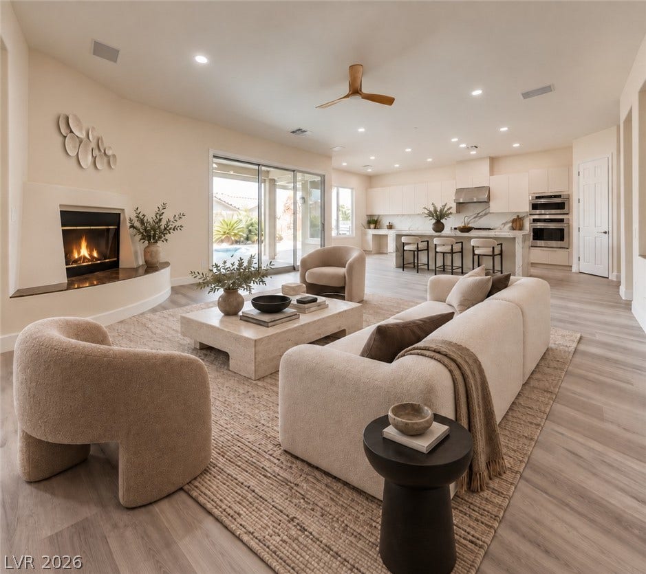 An open floorplan seamlessly connects the fireplace-warmed living room to the gourmet kitchen.