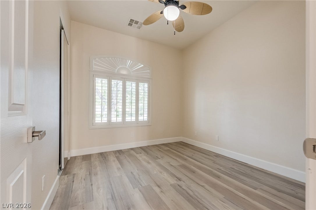 Sunlight streams through custom shutters onto modern wood flooring.