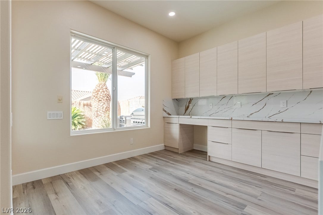 Modern cabinetry and durable wood-look flooring define this versatile workspace.
