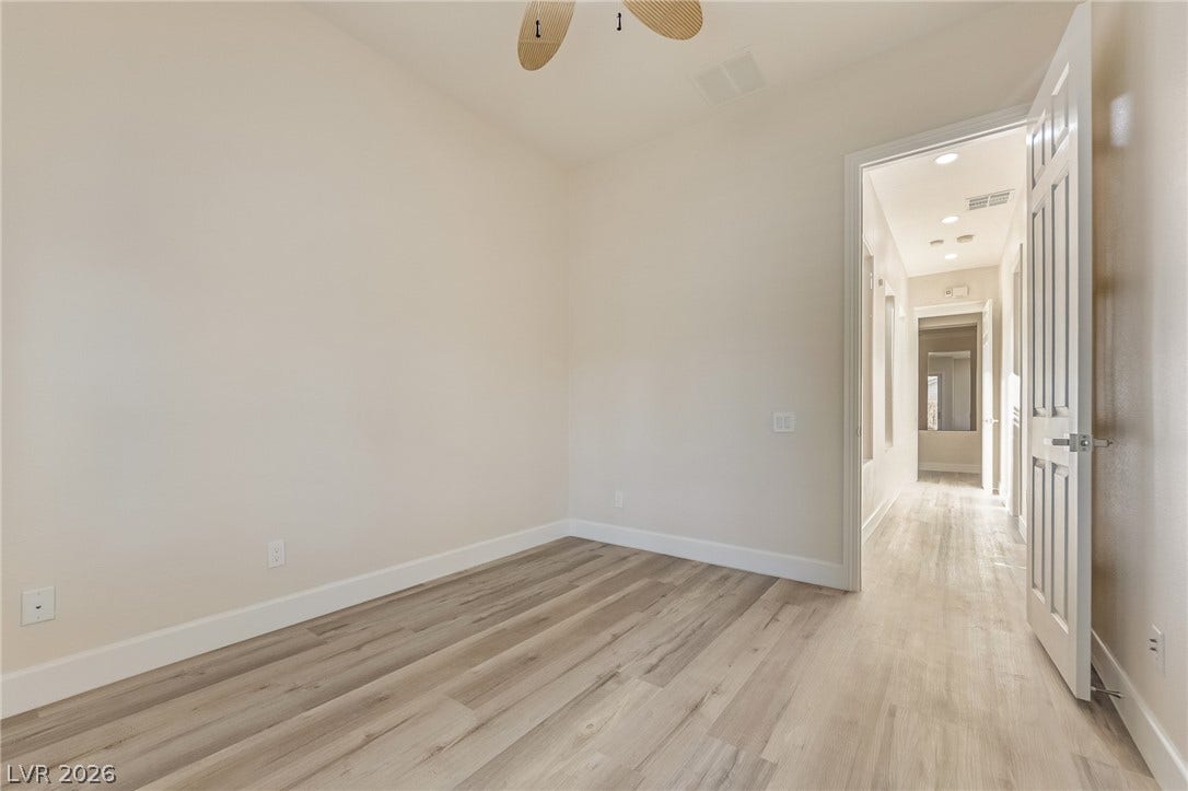 Smooth wood floors and tall baseboards anchor this versatile auxiliary space.